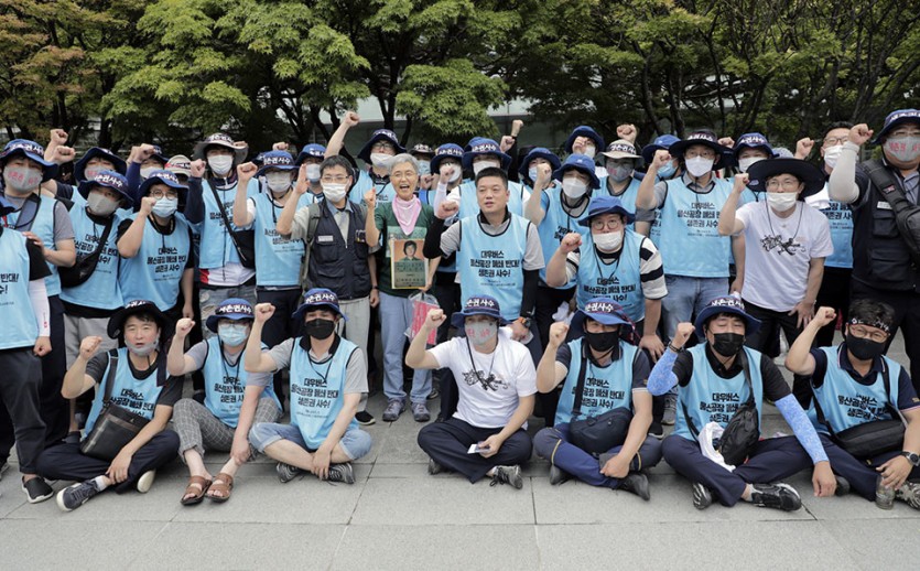 김진숙 금속노조 한진중공업지회 조합원(민주노총 부산본부 지도위원)(가운데)이 7월 28일 오후 서울 여의도 산업은행 앞에서 연 ‘현장으로 돌아가자. 김진숙 복직 응원 기자회견’을 마친 뒤 노조 대우버스지회 조합원들과 함께 사진 촬영을 하고 있다. ⓒ 변백선 기자